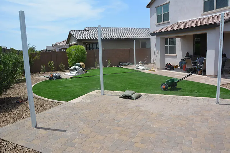 backyard paver pad with pergola post in HOA