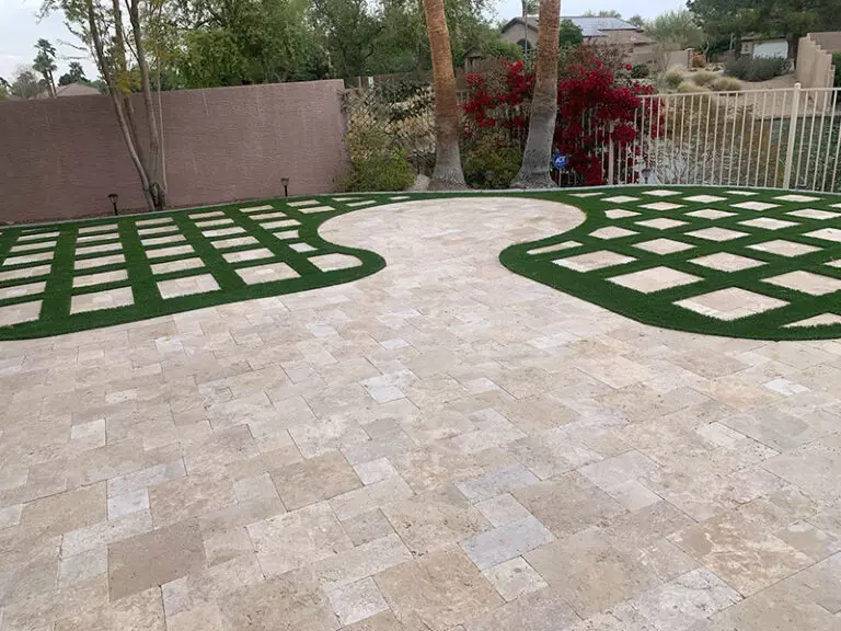 Backyard travertine with synthetic turf inlay