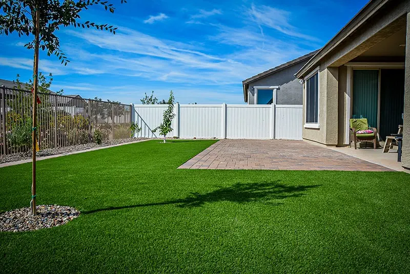 paver patio with artificial grass install in backyard HOA