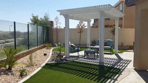 small pergola in backyard with artificial grass